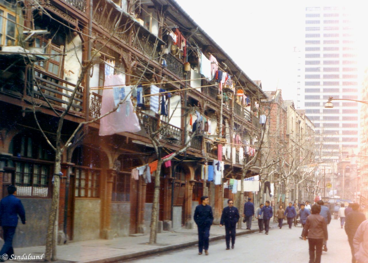 Shanghai back street and sign of the new times in the background China - Shanghai